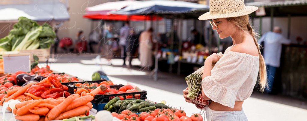 Woman shopping for vegetables at an outdoor market