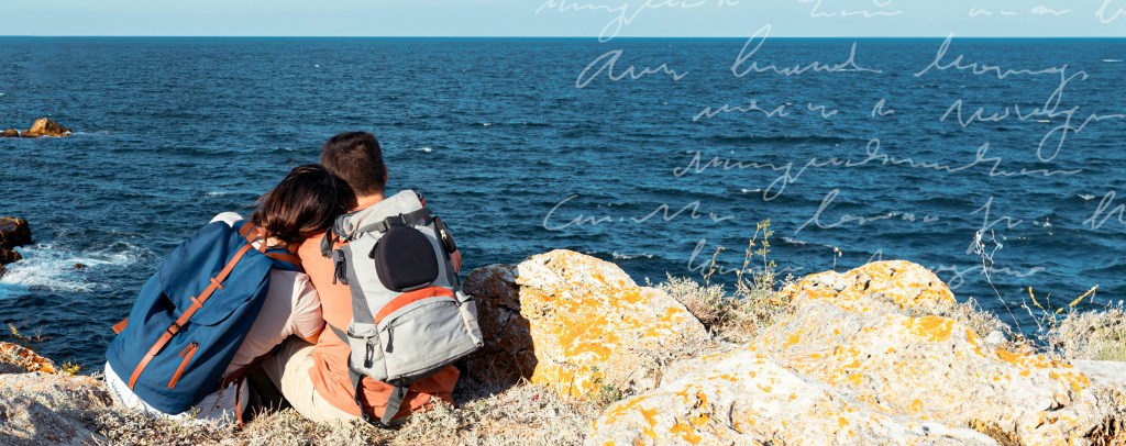 Couple taking a rest on a hike overlooking the ocean