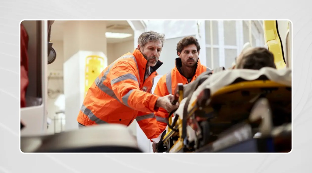Two repatriation officers carrying a stretcher at an airport.